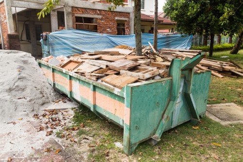 Professional garden clearance team working in a South West London garden